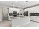 Bright kitchen features an island, modern appliances, stylish pendant lighting, and dark backsplash at 8875 Backspin Ln, Champions Gate, FL 33896