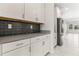 Modern kitchen features white cabinetry, a gray countertop, and stainless steel appliances at 8875 Backspin Ln, Champions Gate, FL 33896