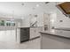 Bright kitchen with white cabinets, stainless steel appliances, large island open to living area at 8875 Backspin Ln, Champions Gate, FL 33896