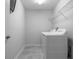 Laundry room with white appliances, overhead shelving, and tile flooring at 8875 Backspin Ln, Champions Gate, FL 33896