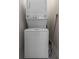A stackable white washer and dryer appliances in the laundry room at 8875 Backspin Ln, Champions Gate, FL 33896
