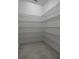 Walk-in pantry featuring ample metal shelving and neutral tile flooring at 8875 Backspin Ln, Champions Gate, FL 33896