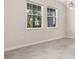Bright, airy room with tile flooring and natural light from two large windows at 8875 Backspin Ln, Champions Gate, FL 33896