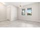 Bright room with tile flooring, natural light from two large windows, and stylish chandelier at 8875 Backspin Ln, Champions Gate, FL 33896