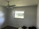 Bedroom with a ceiling fan and a window looking into the backyard at 1257 Dal Maso Dr, Daytona Beach, FL 32117