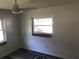 Bedroom featuring wood-look floors, neutral walls, and abundant natural light from the window at 1257 Dal Maso Dr, Daytona Beach, FL 32117