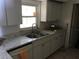 Kitchen with sink, stainless steel faucet, white cabinets, and stone-look countertops at 1257 Dal Maso Dr, Daytona Beach, FL 32117