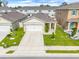 This aerial view highlights a charming single-Gathering home with a two-car garage and landscaped yard at 1335 Berry Ln, Davenport, FL 33837