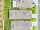 An aerial view of the home's roof and backyard with green grass and fence at 1335 Berry Ln, Davenport, FL 33837