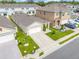 Aerial view showcases a single-Gathering home with a two-car garage and well-manicured lawn at 1335 Berry Ln, Davenport, FL 33837