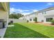 Large backyard with a well-maintained lawn, sliding glass doors, and white vinyl fence at 1335 Berry Ln, Davenport, FL 33837