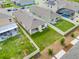 Aerial backyard view featuring a patio, green lawn, privacy fence, and community pool nearby at 1335 Berry Ln, Davenport, FL 33837