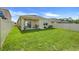 Enjoy outdoor living in this spacious backyard with a covered patio and lush green grass at 1335 Berry Ln, Davenport, FL 33837