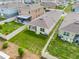 Aerial backyard view with a well-maintained lawn and white fence provides privacy at 1335 Berry Ln, Davenport, FL 33837