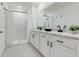 Modern bathroom featuring double vanity sinks and a glass-enclosed shower at 1335 Berry Ln, Davenport, FL 33837