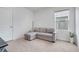 Cozy bedroom with neutral carpet, large window, pullout sofa, and ample natural light at 1335 Berry Ln, Davenport, FL 33837