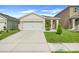 Charming single-Gathering home with a well-manicured lawn, complemented by a two-car garage and modern exterior at 1335 Berry Ln, Davenport, FL 33837
