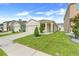 Inviting single-Gathering home with a two-car garage, landscaped yard, and neutral color palette at 1335 Berry Ln, Davenport, FL 33837