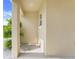 A covered front porch shows a simple, clean design with a white column and minimal landscaping at 1335 Berry Ln, Davenport, FL 33837