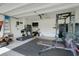 Garage that has been transformed into a home gym with a treadmill and weights at 1335 Berry Ln, Davenport, FL 33837