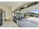 Spacious garage with an exercise rack and mirror at 1335 Berry Ln, Davenport, FL 33837
