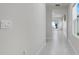Bright hallway with tile flooring and ample natural light. Shows easy access to rooms at 1335 Berry Ln, Davenport, FL 33837