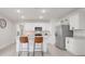 Bright kitchen featuring stainless steel appliances, island seating, and modern finishes at 1335 Berry Ln, Davenport, FL 33837