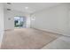 Bright living room featuring neutral carpet, sliding glass doors, and lots of natural light at 1335 Berry Ln, Davenport, FL 33837
