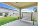 Enjoy the covered patio with a swing overlooking the spacious backyard at 1335 Berry Ln, Davenport, FL 33837