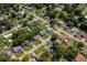 Wide aerial shot showcasing the neighborhood with mature trees and various home styles at 2825 Woodcrest Ln, Lakeland, FL 33805