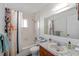 Bright bathroom features a tub with shower, neutral tile and a marble-look vanity with ample counter space at 2825 Woodcrest Ln, Lakeland, FL 33805