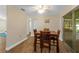 Charming dining room with wood-look tile, a dining table set for four, and sliding doors to screened in lanai at 2825 Woodcrest Ln, Lakeland, FL 33805
