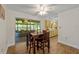 Charming dining room with wood-look tile, a dining table set for four, and sliding doors to screened in lanai at 2825 Woodcrest Ln, Lakeland, FL 33805