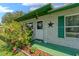 Inviting front entrance with cheerful Welcome sign and vibrant flowering bushes at 2825 Woodcrest Ln, Lakeland, FL 33805