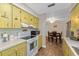 Open-concept kitchen featuring ample cabinet space, a smooth top range, a microwave, and a view into the dining area at 2825 Woodcrest Ln, Lakeland, FL 33805