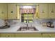 Bright kitchen featuring lots of cabinet space, ample counter space and a window with a view of the back yard at 2825 Woodcrest Ln, Lakeland, FL 33805