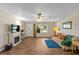 Bright living room with wood floors, decorative fireplace, and comfortable furnishings at 2825 Woodcrest Ln, Lakeland, FL 33805