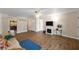 Spacious living room with wood floors, decorative fireplace, and bright, neutral walls at 2825 Woodcrest Ln, Lakeland, FL 33805