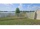 Manicured backyard with a pristine fence and expansive views of the tranquil lake at 2528 Ladoga Dr, Lakeland, FL 33805