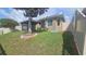 Spacious backyard featuring a fenced perimeter and a tranquil screened-in patio at 2528 Ladoga Dr, Lakeland, FL 33805