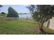 Landscaped backyard with a well-maintained fence and serene lake views at 2528 Ladoga Dr, Lakeland, FL 33805