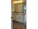 Bathroom features a double sink vanity with granite countertop and white cabinets at 2528 Ladoga Dr, Lakeland, FL 33805