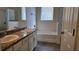 Bathroom featuring a double vanity with granite countertops and a separate bathtub for ultimate relaxation at 2528 Ladoga Dr, Lakeland, FL 33805