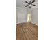 Bedroom boasts hardwood flooring, fan, closet and access to ensuite bathroom at 2528 Ladoga Dr, Lakeland, FL 33805
