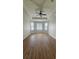 Bedroom featuring wood-look flooring, tray ceiling with fan and bright natural light at 2528 Ladoga Dr, Lakeland, FL 33805
