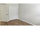 Bedroom featuring wood-look floors, closet, base trim and neutral-colored walls at 2528 Ladoga Dr, Lakeland, FL 33805