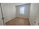 Inviting bedroom featuring neutral walls and wood flooring with natural light at 2528 Ladoga Dr, Lakeland, FL 33805
