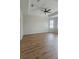 Bedroom offering hardwood floors, tray ceiling with fan, and natural lighting at 2528 Ladoga Dr, Lakeland, FL 33805