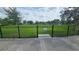 Fenced dog park provides a safe place for dogs to run and play; pet waste station at the entrance at 2528 Ladoga Dr, Lakeland, FL 33805