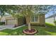 Charming single-story home featuring a well-manicured lawn and inviting curb appeal with a quaint landscape design at 2528 Ladoga Dr, Lakeland, FL 33805